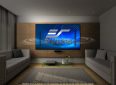 Modern home theater with Elite Screens projector screen on wall.