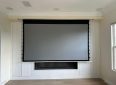 Large wall-mounted projector screen for home theater setups.