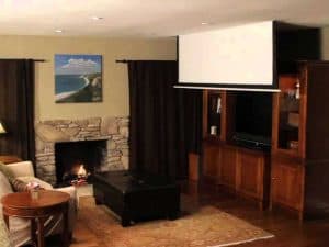 Wall up/down switches for projector screens, ZIW model, installed in a home theater setup.