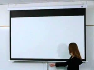 Elite Screens Manual SRM Pro Series projector screen in a classroom setting.