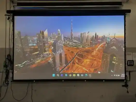 High-quality projector screen displaying a cityscape with skyscrapers and highways.