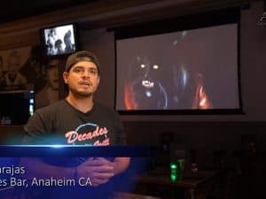 Elite Screens Spectrum Tab-Tension 2 Series projector screen in a home theater.