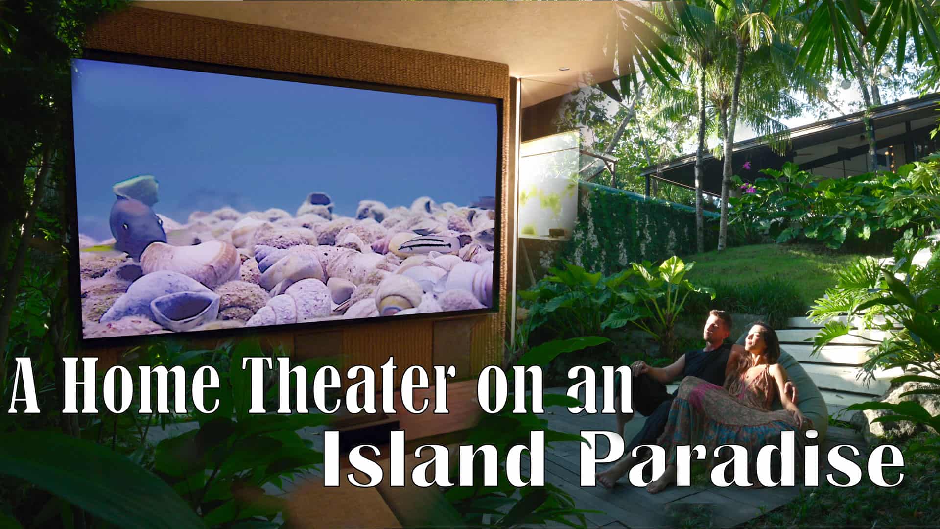Large projector screen in a tropical outdoor setting with two people watching a movie.