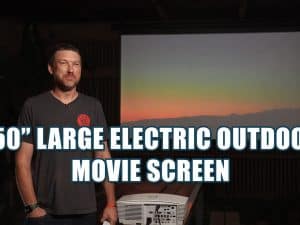 Large outdoor electric projector screen for yard movies.