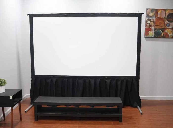 Elite Screens Projector Screen Setup Projector screen with black casing and stand in a modern room.