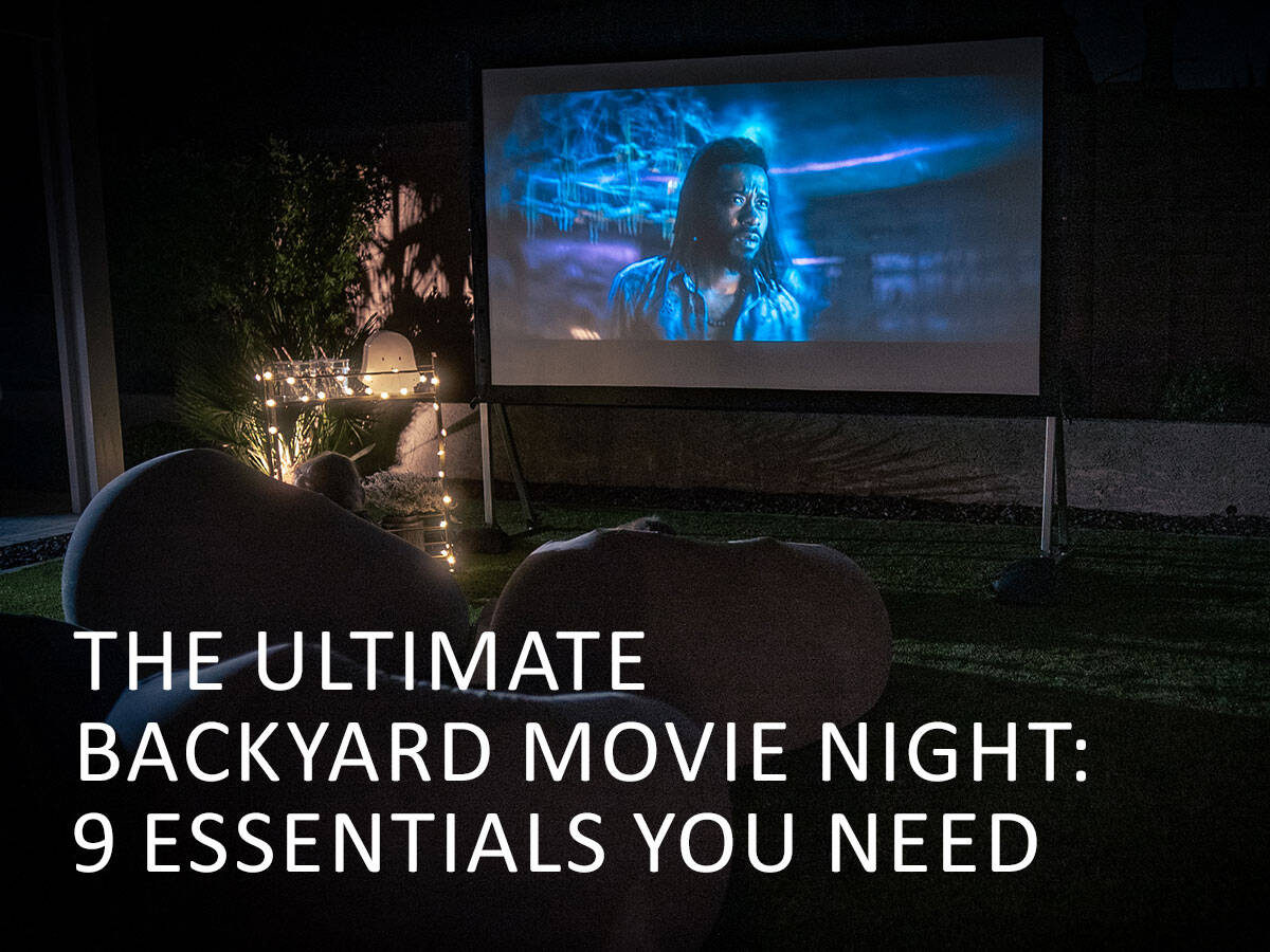 Outdoor projector screen displaying a sci-fi movie at night.