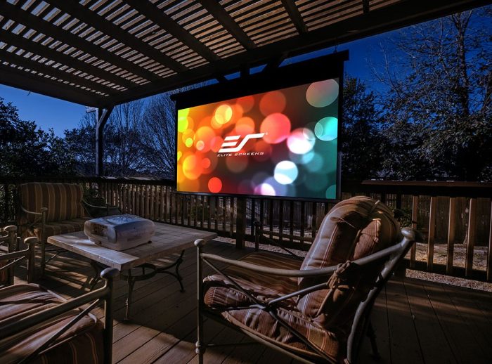 Outdoor projector screen on a patio with seating, perfect for home theater setups.