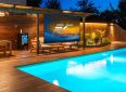 Outdoor projector screen for poolside entertainment and movies.