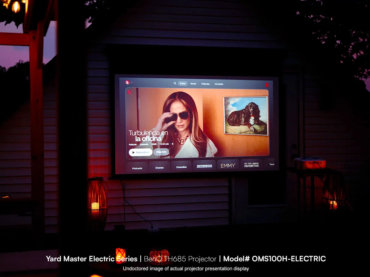Elite Screens outdoor projector screen display at dusk with woman on screen and landscape image.